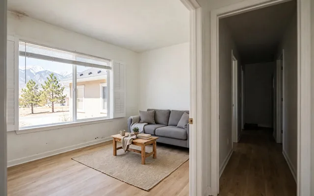 Mold in a Colorado rental: an empty living room with a window and a hallway doorway, where a tenant may first notice a musty smell