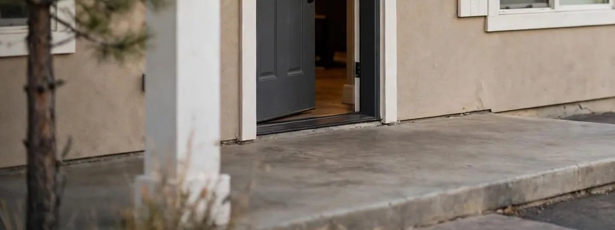 Crawl space mold remediation Littleton: a porch slab and foundation edge beside the front door of a Colorado home